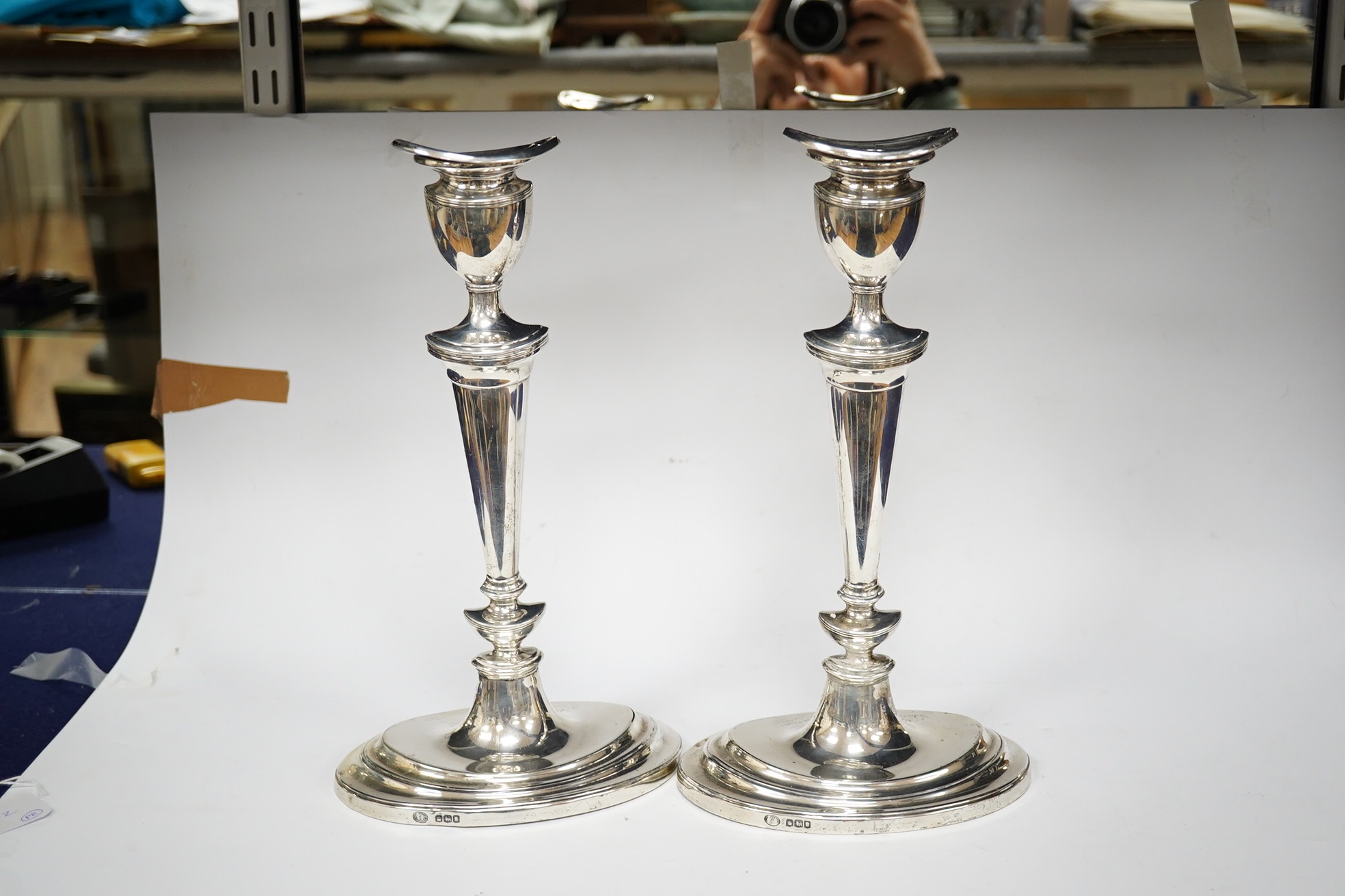 A pair of George V silver oval candlesticks, with engraved inscription, Hawksworth, Eyre & Co, Sheffield, 1919, 30cm, weighted. Condition - fair